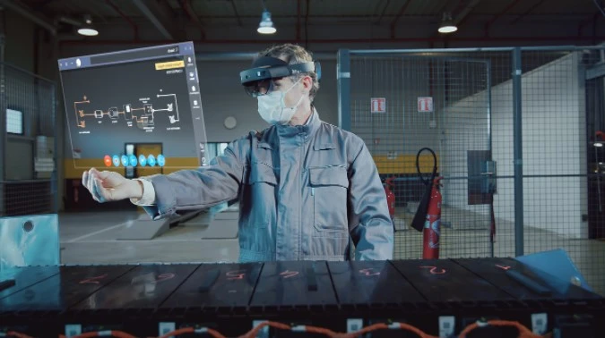 Person pulling up a diagram using Hololens 2.