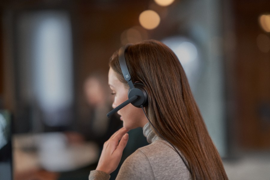 Close-up side view of a woman wearing a headset.